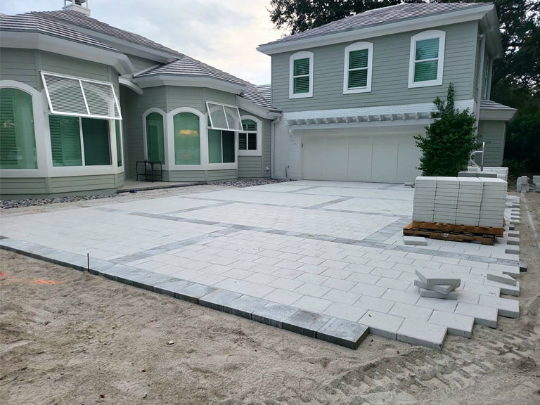 Contrasting grid patterned driveway installation | Love's Landscape Landscape Installation & Maintenance Company