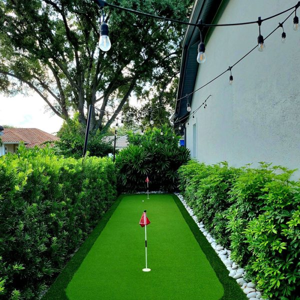Side Yard Putting green with bistro lights | Love's Landscape Landscape Installation & Maintenance Company